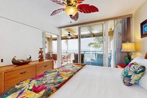 a bedroom with a large bed and a balcony at Flip Flops & Sand Beach house in Wells