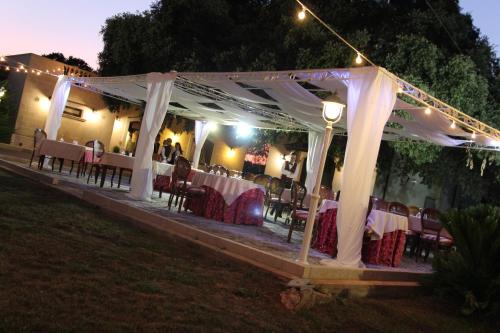 a marquee with tables and chairs under a white tent at Tenuta Antico Leccio in Gioia del Colle