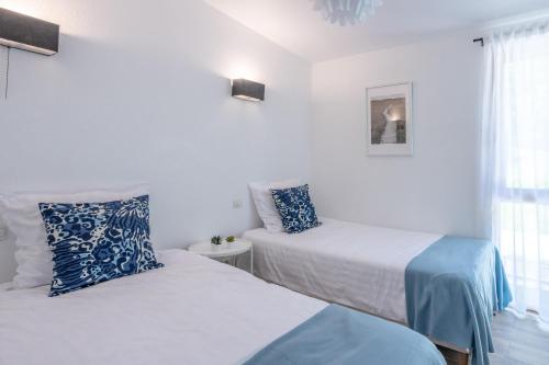 a bedroom with two beds and a window at Les Charmes C10 - Le Val Joly in Eppe-Sauvage