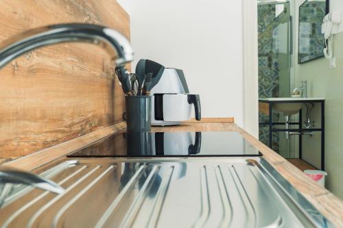 a kitchen counter with a sink with a coffee maker at ADA Apartment in Porto Cesareo