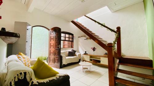 a living room with a couch and a staircase at Hostel Agatha in Paraty