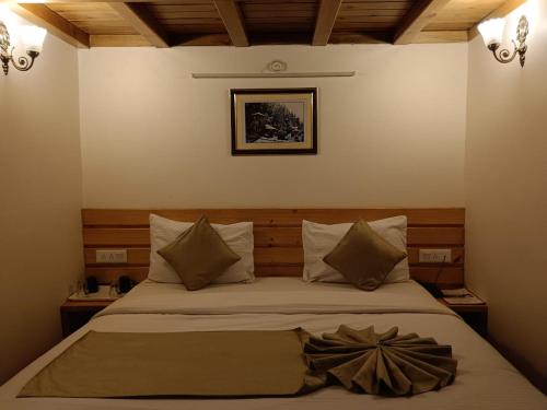 a bedroom with a bed with a flower on it at The Kumaon Retreat in Nainital