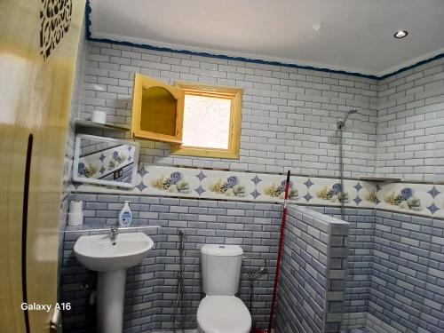 a bathroom with a white toilet and a sink at Smart House in Chefchaouen