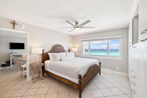 a bedroom with a bed and a view of the ocean at Emerald Hideaway by 30A Escapes in Carillon Beach