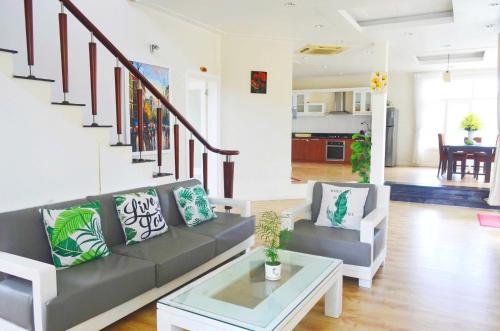 a living room with a couch and a table at Villa Sealink S15 in Ấp Thiện Phước
