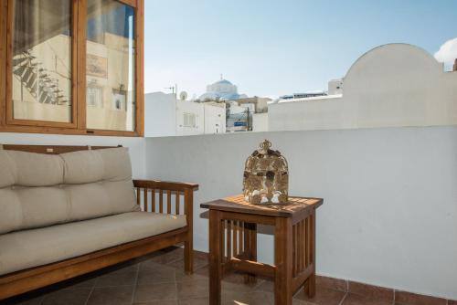 a living room with a couch and a table at Alexandra's Home in Fira