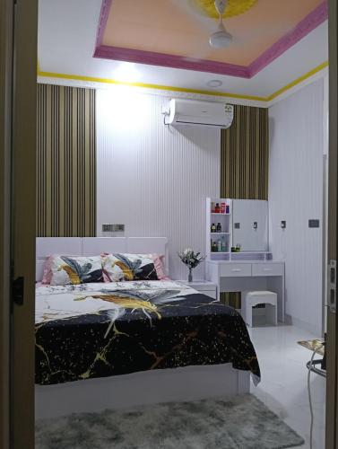 a bedroom with a bed and a desk at Save Sweet Home in Fuvahmulah