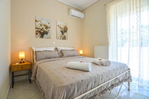 a bedroom with a bed with two towels on it at Aelia Luxury Suites Melissi in Xylokastro