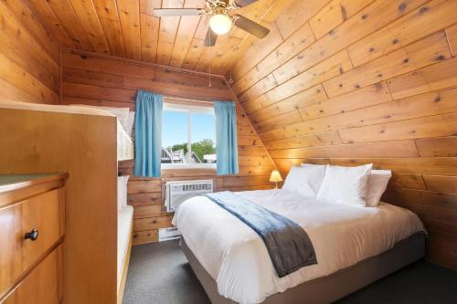a bedroom with a bed in a wooden cabin at Chalet #25 in Stevensville