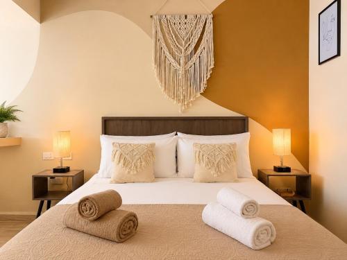 a bedroom with a bed with towels on it at Syrena Luxury Caribbean - Heart of Playa del Carmen - Sea Views in Playa del Carmen