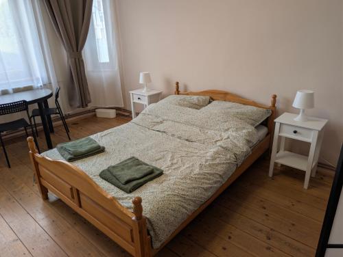 a bedroom with a bed with two pillows on it at Hostel Kalinowskiego in Żary