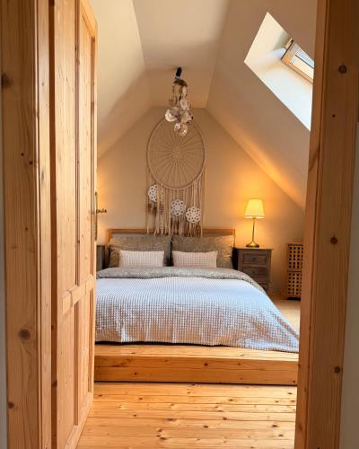a bedroom with a large bed in a attic at Kouzelný domeček in Ostrava