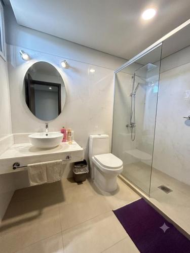 a bathroom with a toilet and a sink and a shower at Viel Comfort II in Asunción