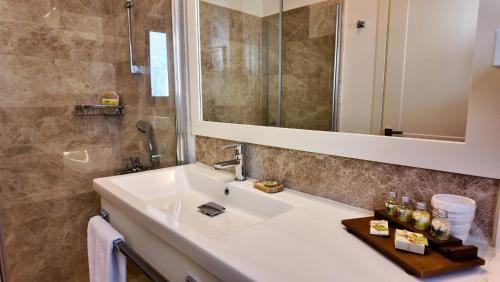a bathroom with a sink and a mirror at D&C Göcek Hotel in Göcek