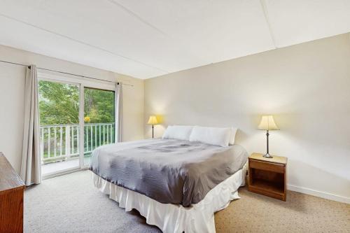 a bedroom with a bed and a large window at Seasons 304 in Warren