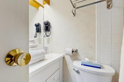 a white bathroom with a toilet and a sink at Seasons 304 in Warren