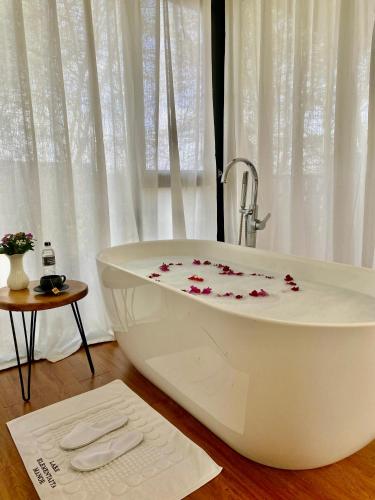 a white bath tub with flowers on it in a bathroom at Lake Elementaita Manor in Gilgil
