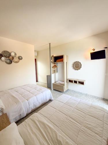 a bedroom with a large bed and a television at Tota Marinou in Agioi Apostoli