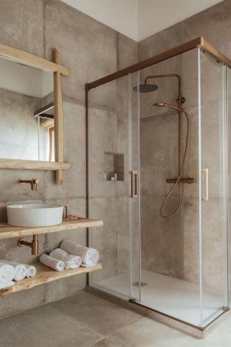 a shower with a glass door in a bathroom at Locanda delle rose in Roccavaldina