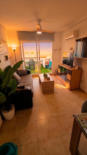 a living room with a couch and a large window at Apartalux Magic Platinum in Oropesa del Mar