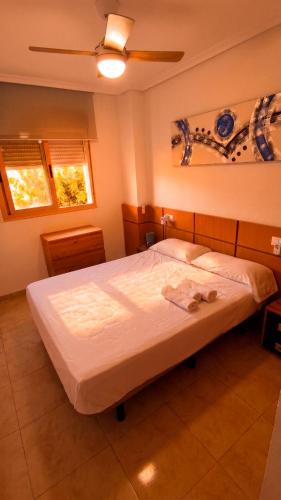 a bedroom with a large bed with white sheets at Apartalux Magic Platinum in Oropesa del Mar