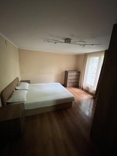a bedroom with a white bed and a window at Mtskheta Oasis Garden in Mtskheta