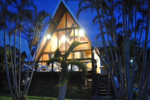 a house with palm trees in front of it at Sea Breeze in Onna