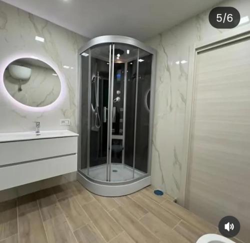 a bathroom with a shower and a sink and a mirror at B&b Antonia in SantʼAntonio Abate