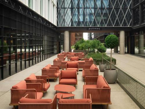 a row of chairs and tables in a building at Pullman Zagreb in Zagreb