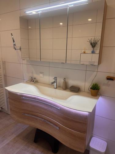 a bathroom with a sink and a mirror at Shine Home in Klagenfurt