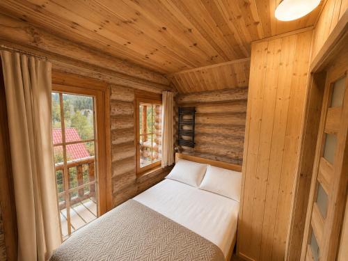 a small bed in a room with a window at Pod Smrekami in Sól