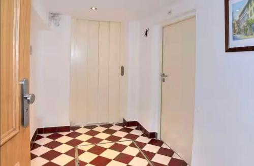 a room with a checkered floor and a door at FeWo3 in Lindau