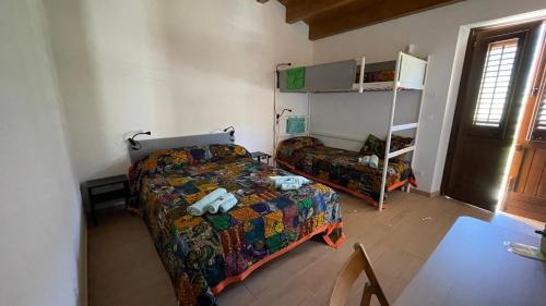 a bedroom with a bed and a couch and a ladder at Orto Raccolto in Termini Imerese