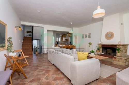 a living room with a couch and a fireplace at Casa Cyra in Alexandroupoli