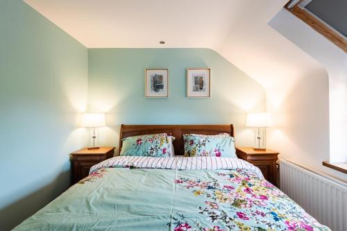 a bedroom with a bed with two lamps on both sides at Corlea Studio in Dunwish