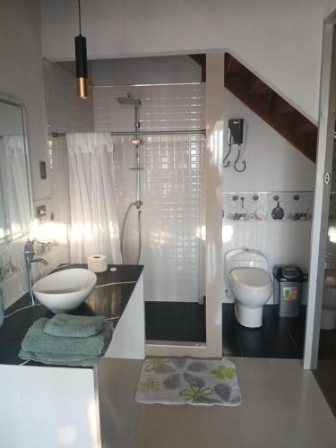 a bathroom with a sink and a toilet at Casa Berenice in Zorritos
