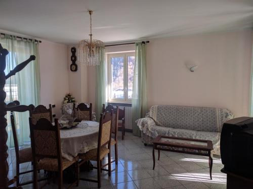 a living room with a table and a couch at Residenza Nonna Lucia in Roccaforte Mondovì