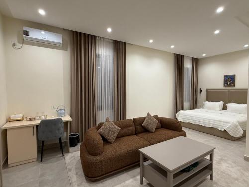 a living room with a couch and a bed at Hotel Bogatt in Dushanbe