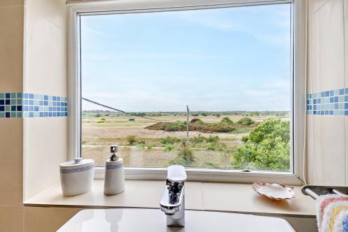 a window with a view of a field at 3 Bed in Felixstowe oc-h32096 in Walton