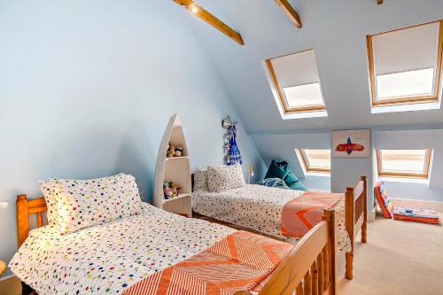 a childs bedroom with two beds and windows at 3 Bed in Felixstowe oc-h32096 in Walton