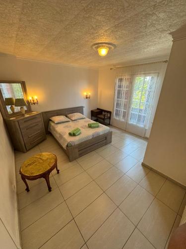 a bedroom with a bed and a table in it at La Galiote in Agde
