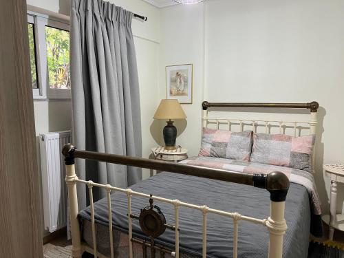 a bedroom with a bed and a window at Alonaki House in Amfikleia