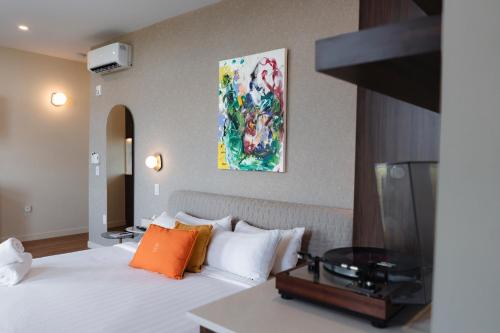 a hotel room with a bed and a painting on the wall at Arcadia Hotel Boutique in Montreal