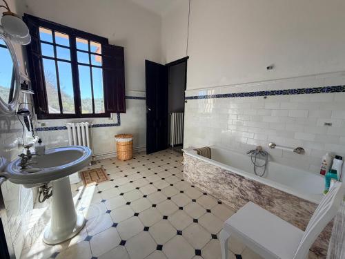 a bathroom with a sink and a bath tub at La Almedina: Palacio de Foronda in Cazorla