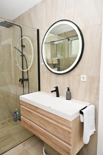 a bathroom with a white sink and a mirror at Villa NOA in Jajce