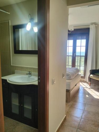 a bathroom with a sink and a bed and a mirror at Punta Brisa Marina in Punta del Caimán