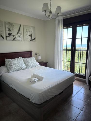 a bedroom with a large bed with white sheets at Punta Brisa Marina in Punta del Caimán