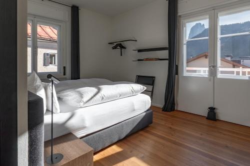 a bedroom with a bed and a large window at Casa al Sole in Ortisei