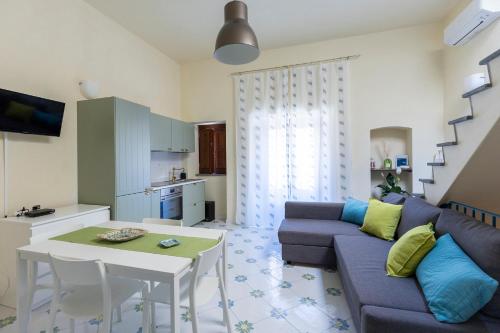 a living room with a couch and a table at Il Veliero Blu Suite Lipari Centro - Corso Vittorio Emanuele in Lipari