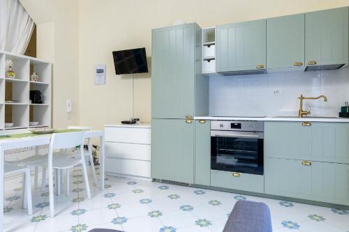 a kitchen with blue cabinets and a sink and a stove at Il Veliero Blu Suite Lipari Centro - Corso Vittorio Emanuele in Lipari
